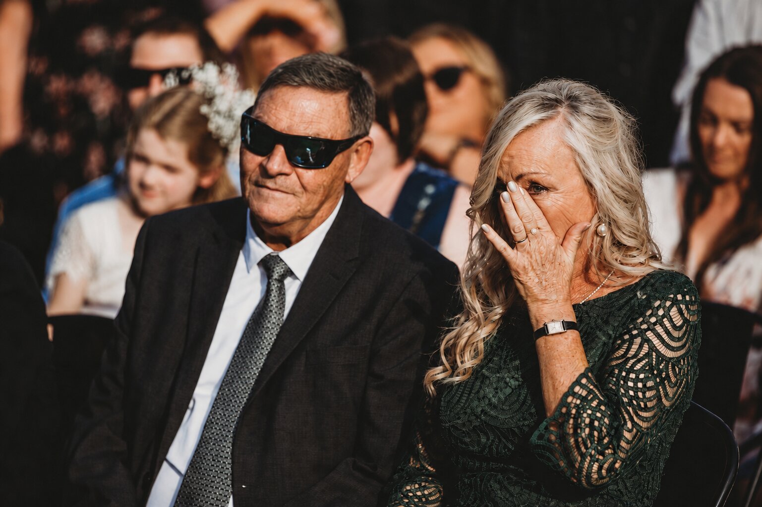 Family in the front row wiping away happy tears during the ceremony