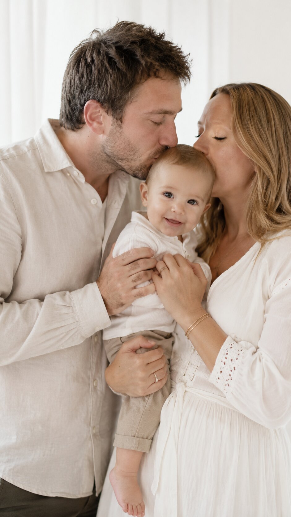 The couple holding their baby, now a family of three